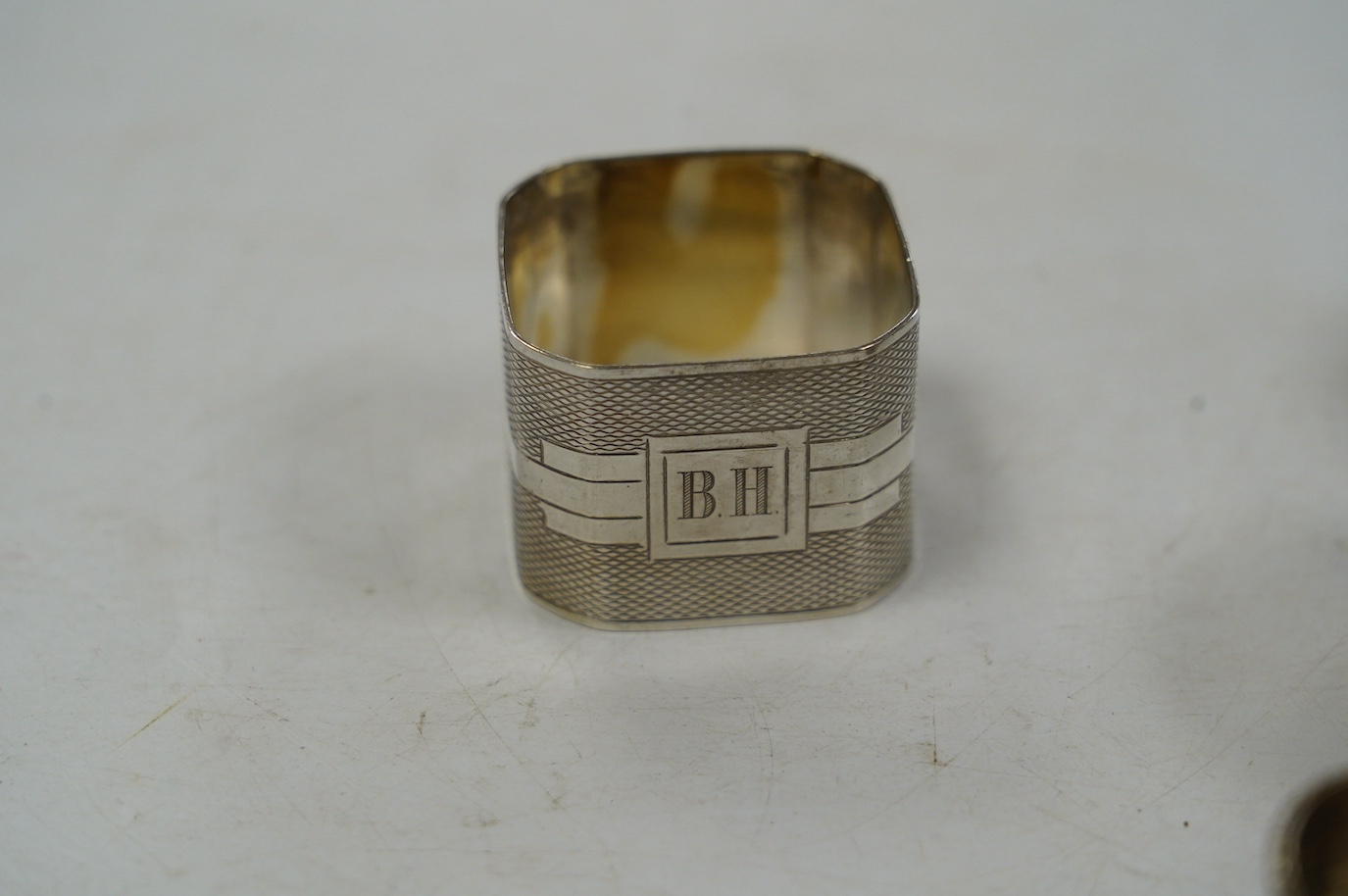 Eight assorted silver napkin rings, including a pair, Birmingham, 1937 and four plated napkin rings. Condition - fair